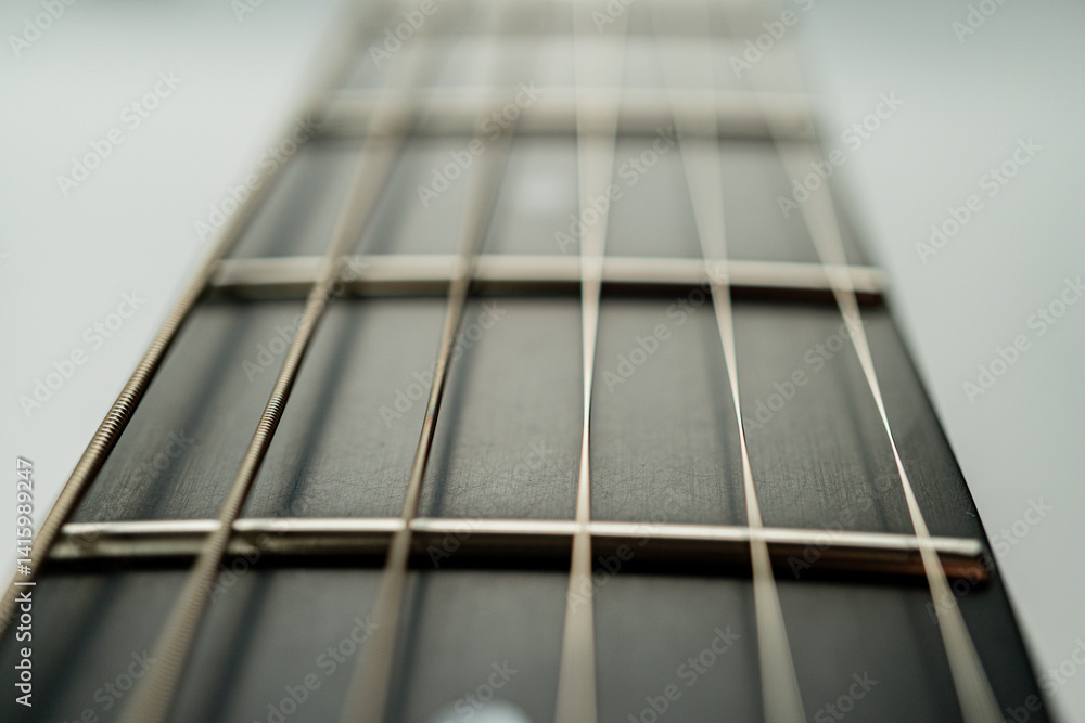 Close-up image of a guitars fretboard, highlighting meticulous craftsmanship and frets for accurate tuning Close-up image of a guitars fretboard, highlighting meticulous craftsmanship and frets for accurate tuning