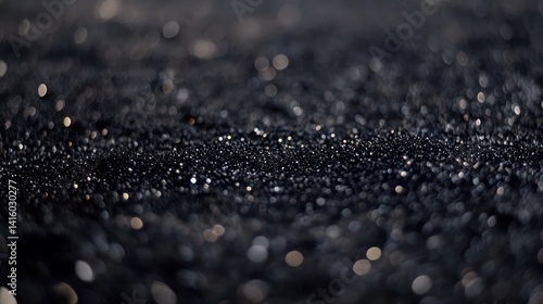 Sparkling black sand beach sunset bokeh background texture