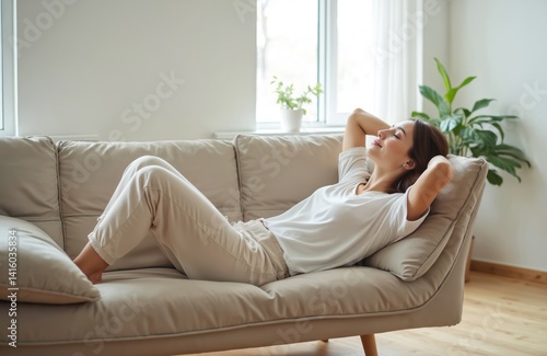 Young woman rests on comfy sofa. Peaceful Caucasian girl relaxing, taking nap in living room. Happy female rest, enjoying leisure time, stress-free at home. Serene atmosphere, wellness concept.