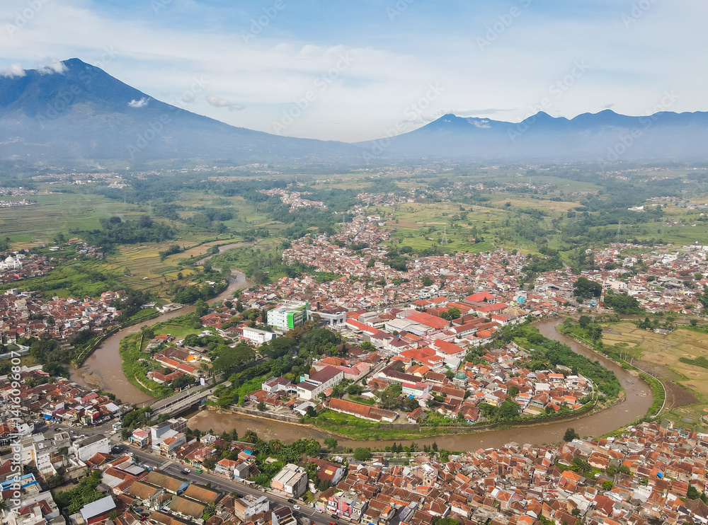 Aerial view of the residential area and its surroundings of Garut city with Mount Cikuray in the background and the Cimanuk River also visible. Garut is a district in West Java, Indonesia.