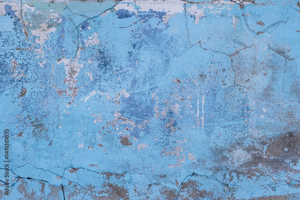 Vintage wall texture. Rough surface of the plastered concrete wall of the building. A pattern with many cracks and old faded peeling paint. Perfect for background and design. Closeup.