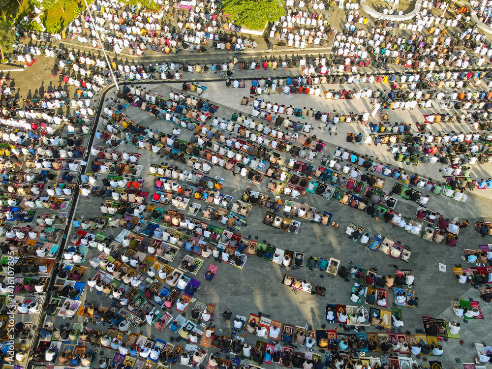 The Muslim community in Garut Regency, Indonesia, together performs Eid prayers in the courtyard of the Grand Mosque of Garut Regency, which is also the town square of Garut, seen from above.