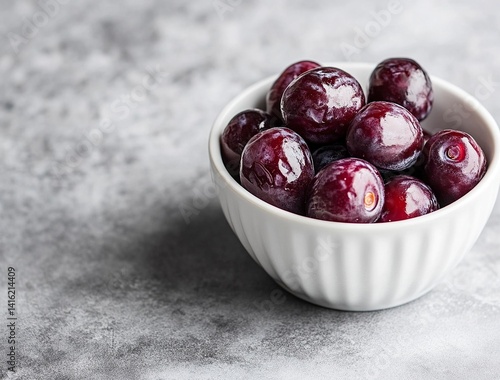 Ripe dates in a white bowl on a grey background, close-up view. Ramadan food concept with copy space for text or design. Fresh date fruits. Stock photo contest winner, high resolution, high detail, na