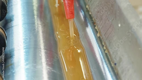 Efficient glue application technique on rollers for optimal adhesion in manufacturing processes