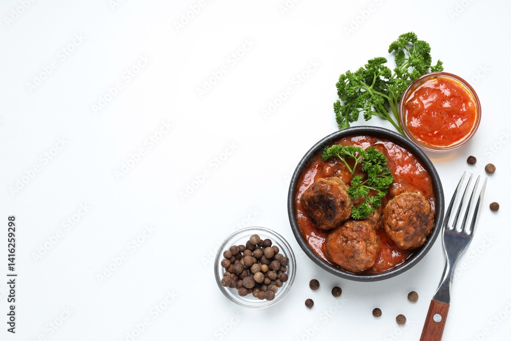 Meatballs in a bowl with spices and sauce on a light background