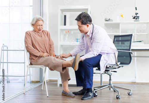 Obraz na płótnie Asian orthopedic doctor consultation explaining treatment methods of trauma to retired old woman leg injury knee pain of patient in hospital physical therapy rehabilitation medical health care support w salonie