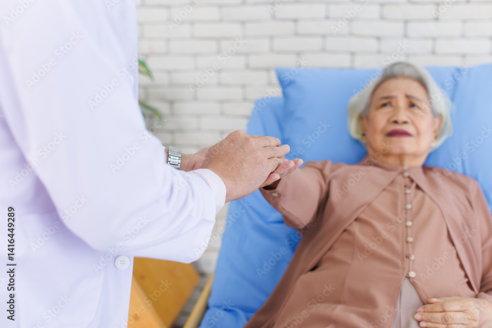 Asian senior woman lay on bed with doctor closeup holding hands with empathy care to trust support or help at hospital, Healthcare elderly patient and medical professional consultation wellness being.