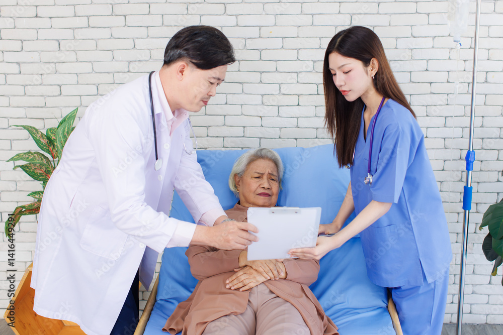 Asian senior woman happy lay on bed while consulting examining with doctor and caring nurse checking in hospital Healthcare elderly patient and medical professional support consultation wellness being