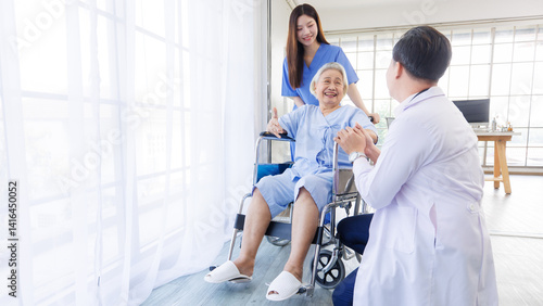 Obraz na płótnie Asian old woman sitting smile with doctor and caring nurse near window in nursing home hospital, consultation caregiver helping support healthcare to elderly senior medicals recovery service wellness. w salonie