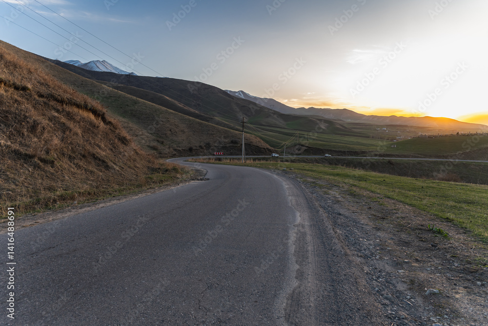 Fototapeta premium Mountain road, serpentine in Kyrgyzstan at sunset.