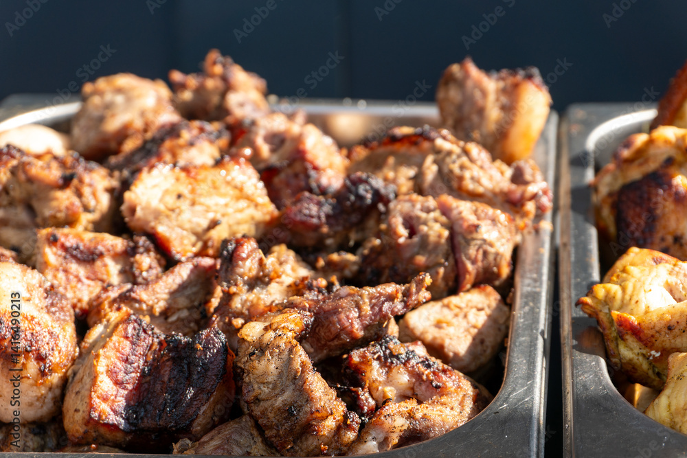 Grilled Pork Pieces on a Metal Tray Grilled Pork Pieces on a Metal Tray