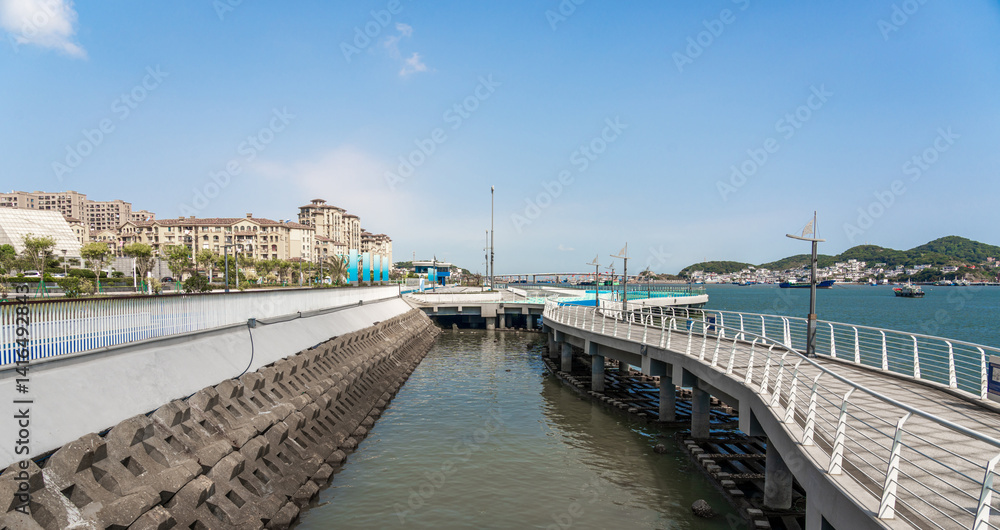 Scenic Waterfront View with Modern Pier and Coastal Landscape Scenic Waterfront View with Modern Pier and Coastal Landscape
