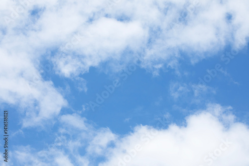 Obraz na płótnie Blue sky background and white clouds soft focus, and empty space in middle, horizontal shape. w salonie