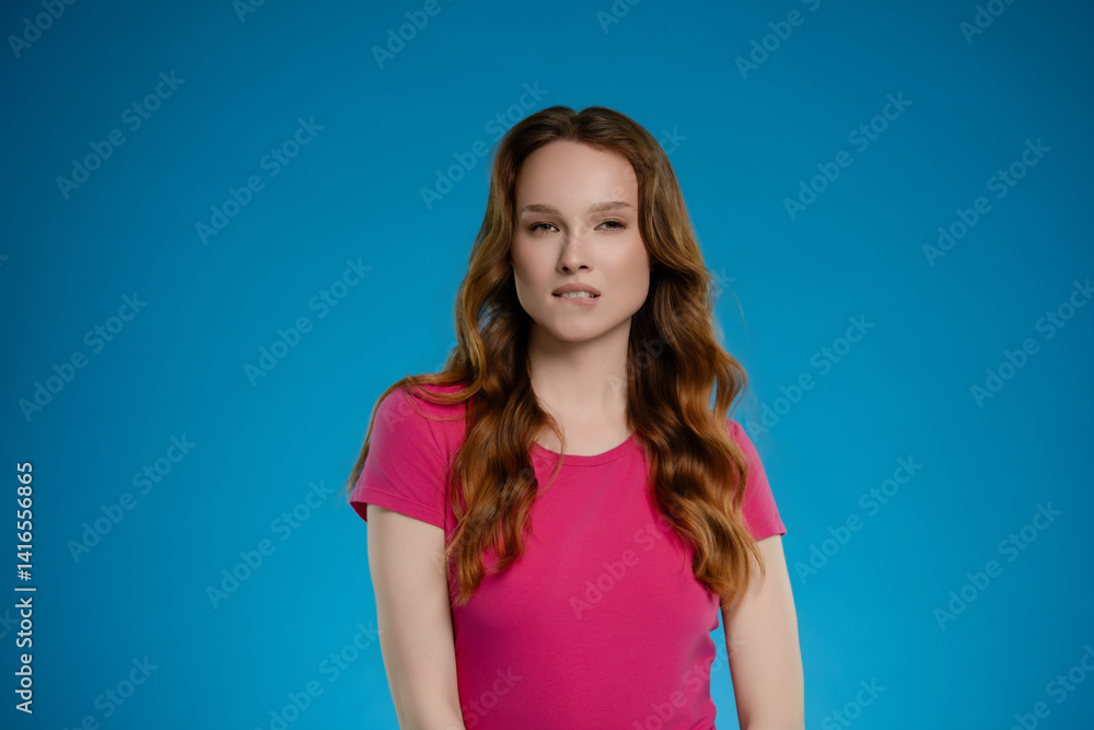 Woman posing in a studio setting with a bright blue background, conveying a range of emotions and expressions