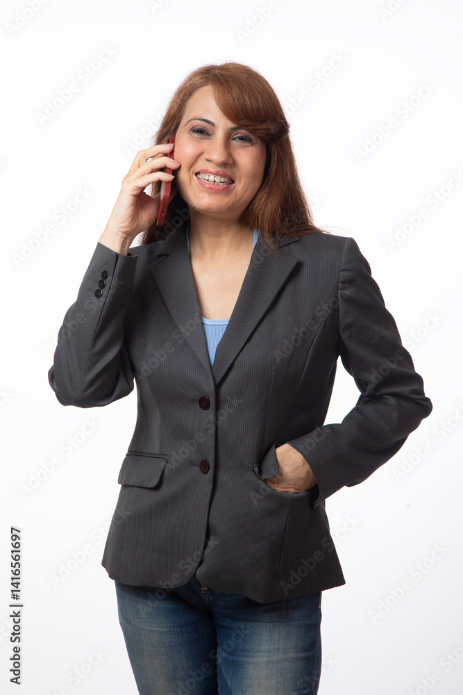 Indian business or corporate woman using mobile phone against white background Indian business or corporate woman using mobile phone against white background