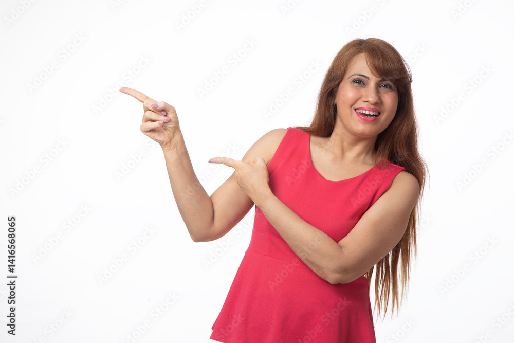 Portrait of happy smiling woman pointing finger isolated on studio background. Indian woman looking at camera pointing at copy space in formal clothes isolated in white Portrait of happy smiling woman pointing finger isolated on studio background. Indian woman looking at camera pointing at copy space in formal clothes isolated in white