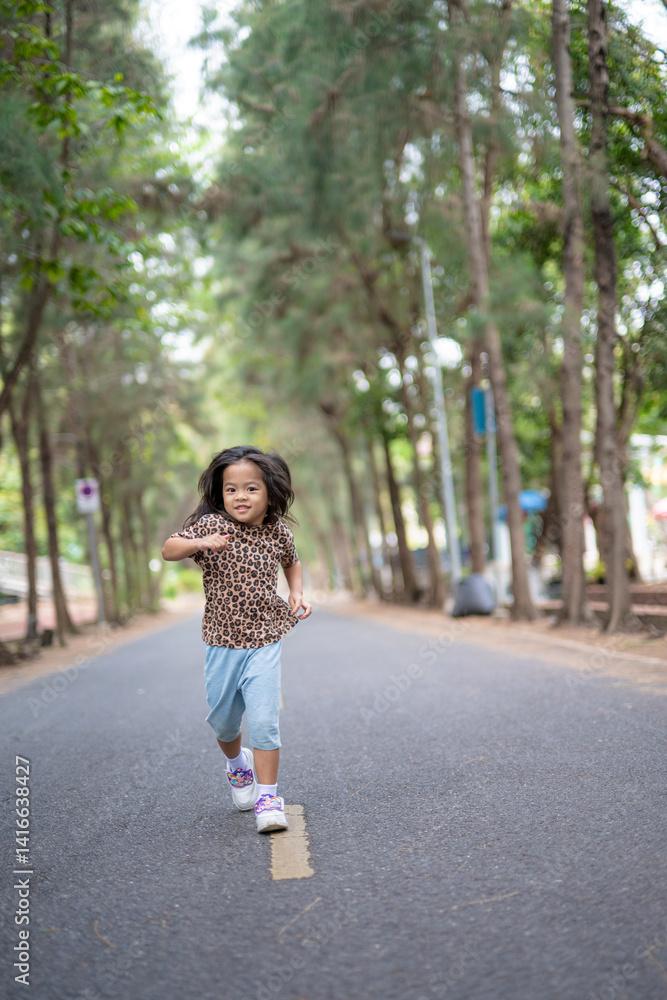 Little asian girl enjoy outdoor run park tree forest