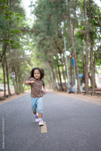 Little asian girl enjoy outdoor run park tree forest
