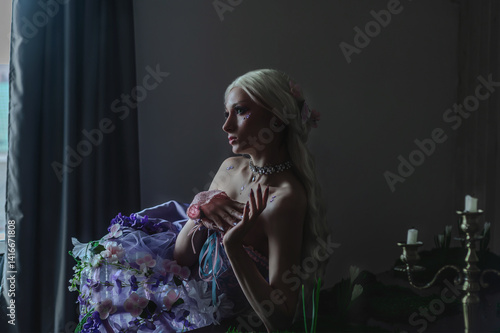 Fototapeta A girl dressed in the style of a Victorian boudoir, in a corset and crinoline of