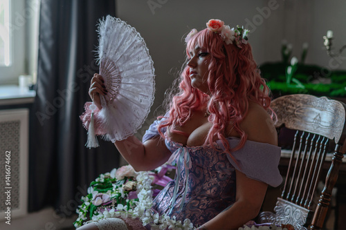 Fényképezés A girl dressed in the style of a Victorian boudoir, in a corset and crinoline of