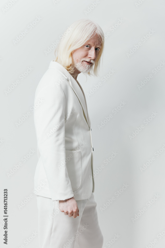 Elegant man in white suit, showcasing a confident pose against a light background Minimalistic style emphasizing sophistication and modernity Elegant man in white suit, showcasing a confident pose against a light background Minimalistic style emphasizing sophistication and modernity