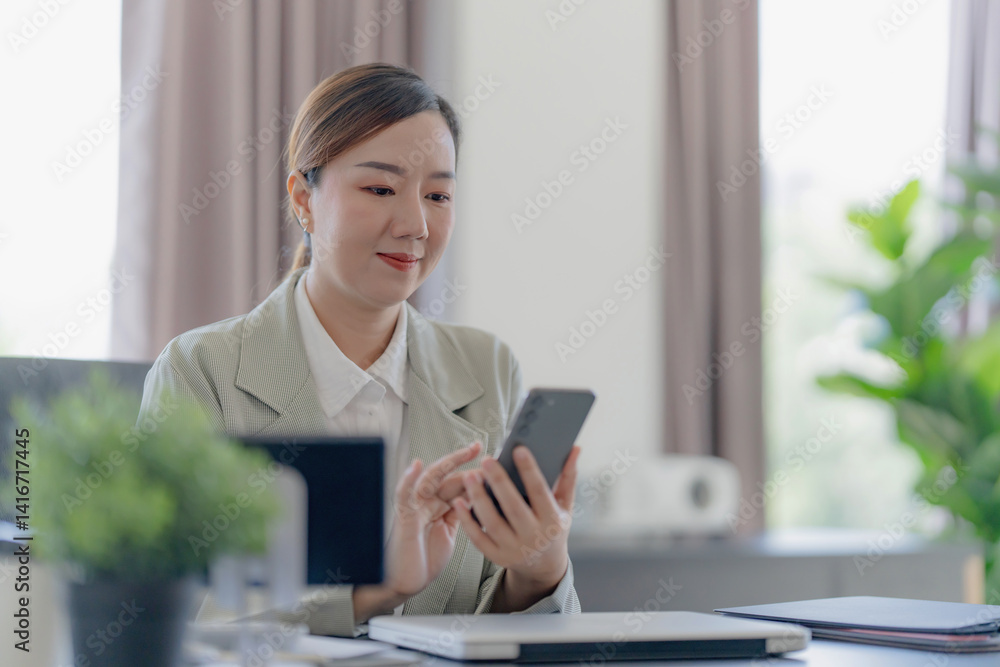 Middle aged asian woman working on documents data at contemporary office Middle aged asian woman working on documents data at contemporary office