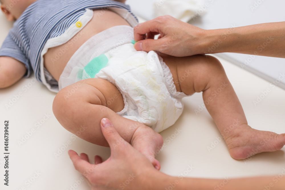 Newborn baby wearing diaper during diaper change