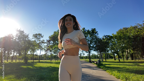 Obraz na płótnie Young woman running and jogging in urban park. w salonie