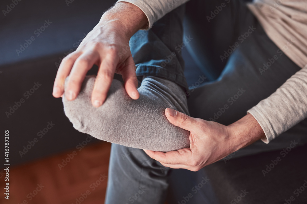 Man with ankle and foot pain at home.