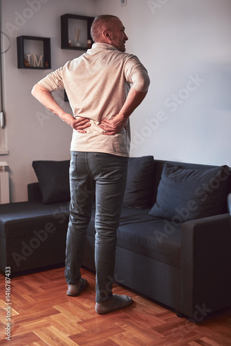 Obraz na płótnie Man with hip, back and sciatica pain at home. w salonie