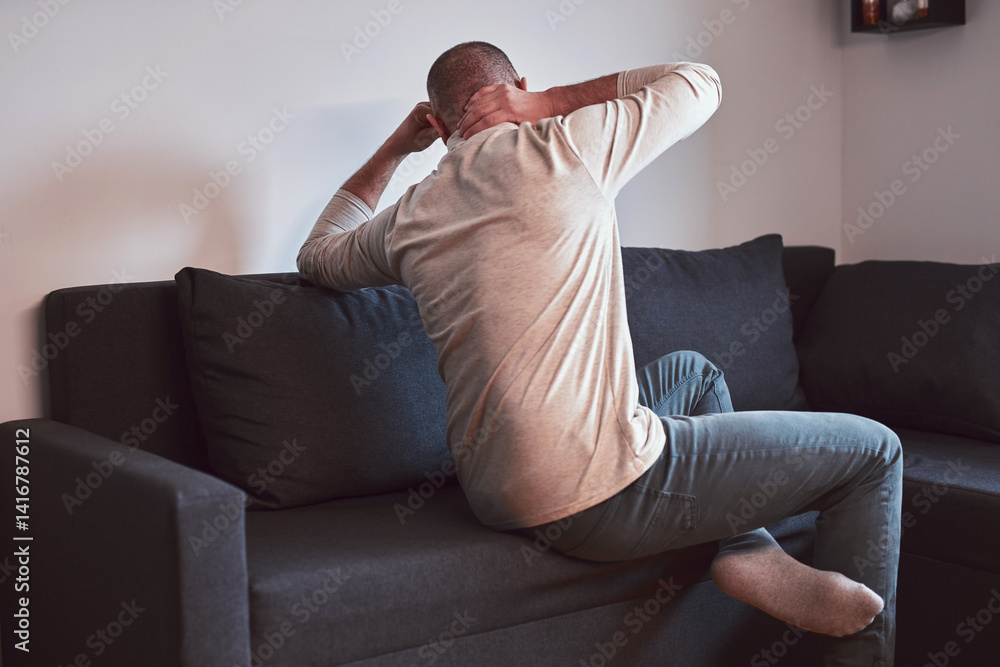 Man with neck pain at home.