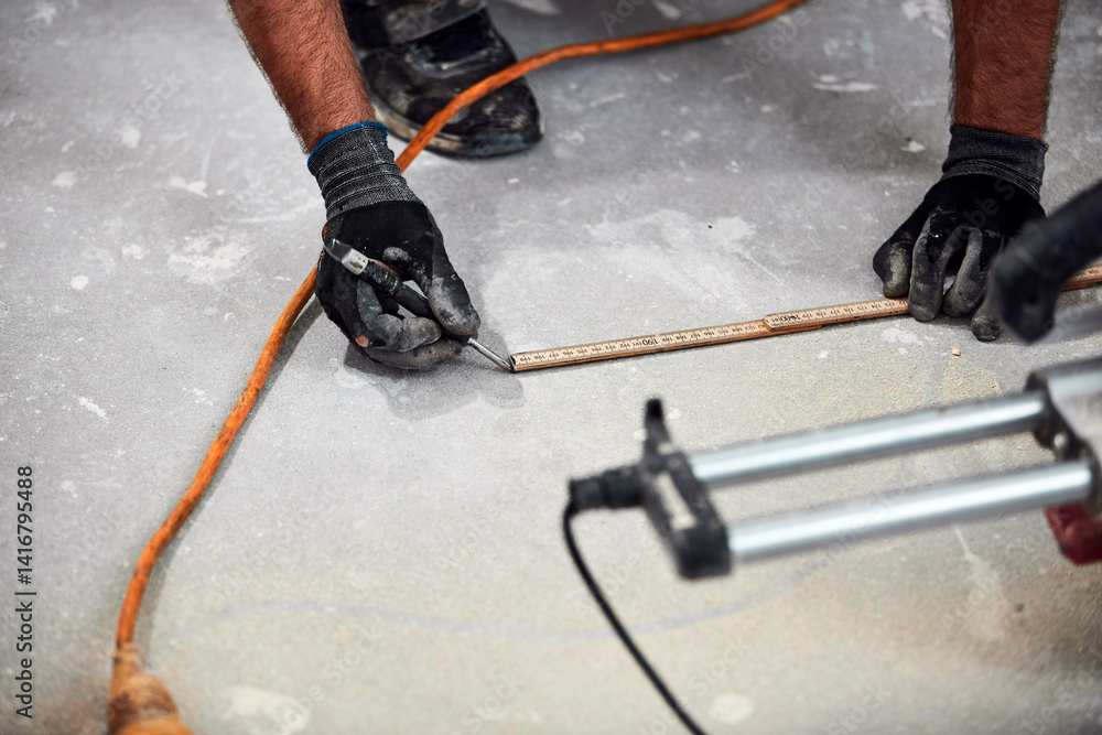 Professional handyman installing laminate flooring in a new apartment.
