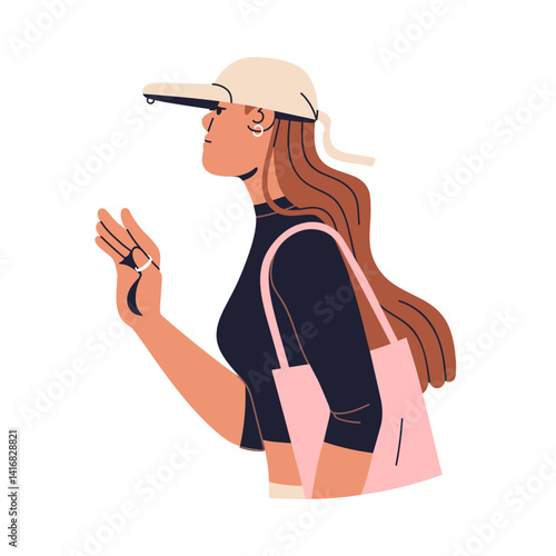 Stylish young woman, wearing baseball cap and tote bag. Fashion female walkin...