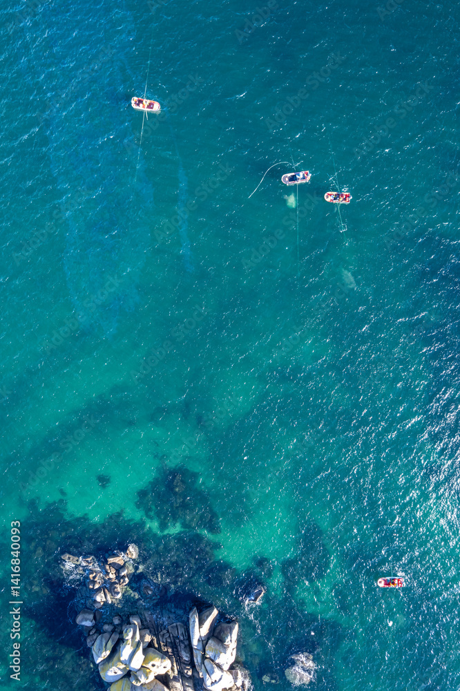 Tranquil ocean scene, High angle view of boats on sparkling turquoise. top down drone photo Tranquil ocean scene, High angle view of boats on sparkling turquoise. top down drone photo