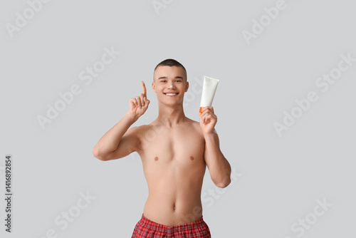 Happy young man with bottle...