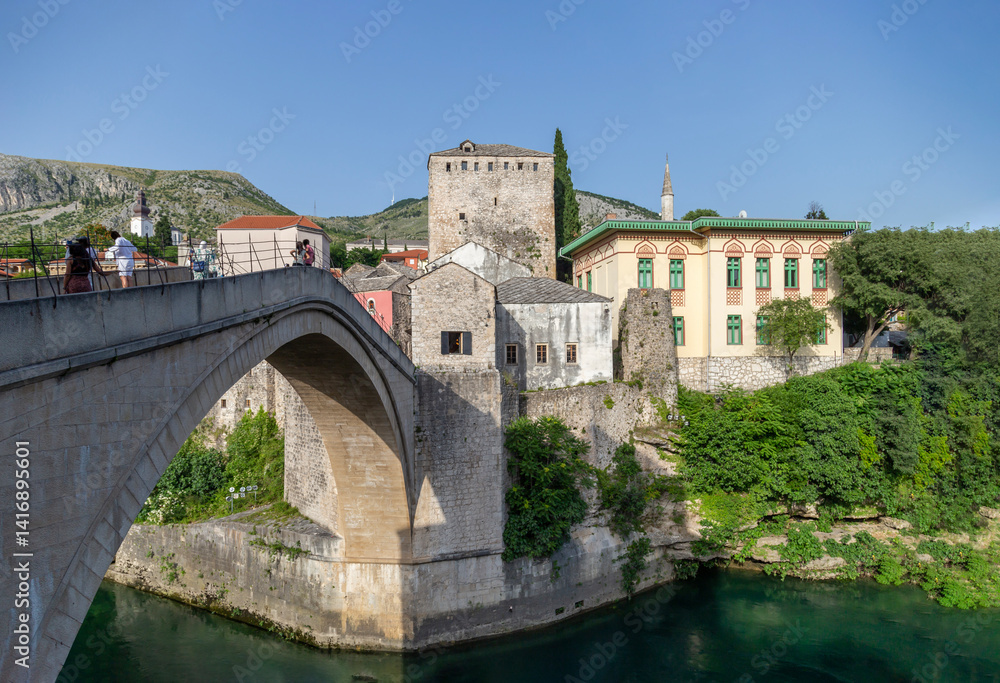 Mostar Bridge is a bridge located on the Neretva river passing through the city of Mostar in Bosnia and Herzegovina. The Mostar bridge was built 30 meters long, 4 meters wide and 24 meters above Mostar Bridge is a bridge located on the Neretva river passing through the city of Mostar in Bosnia and Herzegovina. The Mostar bridge was built 30 meters long, 4 meters wide and 24 meters above