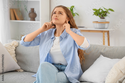 Papier peint Young woman suffering from loud neighbours at home