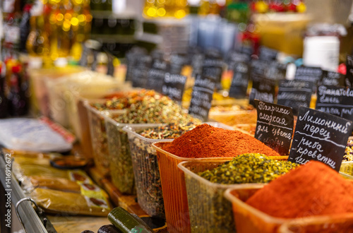 Fototapeta Naklejka Na Ścianę i Meble -  Various spices, peppers and herbs close-up top view. Eastern spice market. A set of peppers and spices for cooking. Assortment of various oriental spices on the counter at the Asian bazaar in close-up