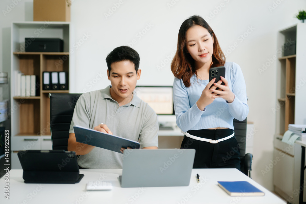 Two business workers talking on the smartphone and using laptop Two business workers talking on the smartphone and using laptop