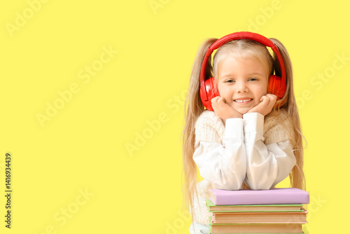 Cute little girl in headpho...