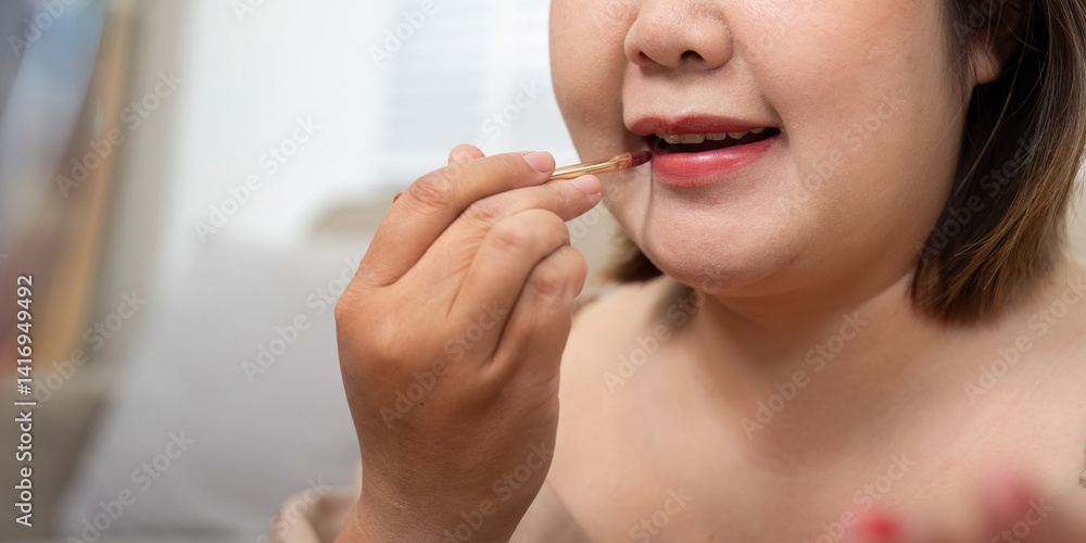 Lip Makeup and Confidence. A woman applying lipstick with elegance, showcasing her beauty routine. Lip Makeup and Confidence. A woman applying lipstick with elegance, showcasing her beauty routine.