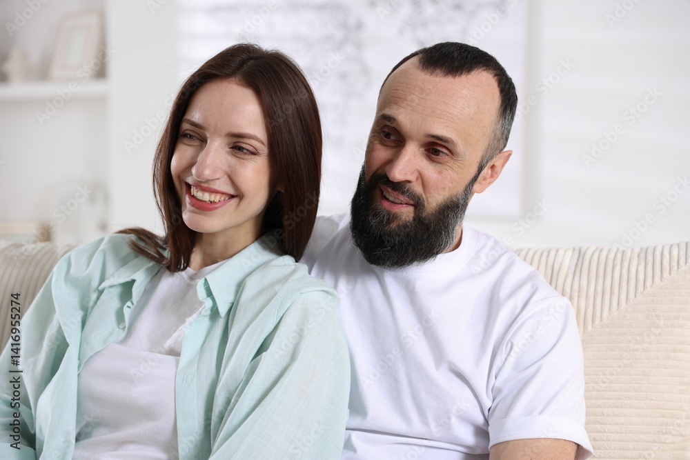 Happy daughter and father on sofa at home Happy daughter and father on sofa at home
