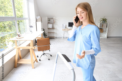Female doctor talking by mo...