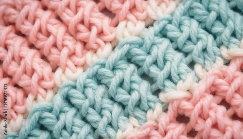 Close-up of colorful knitted fabric showcasing intricate patterns in pastel pink and blue