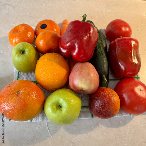 Close-up view of freshly washed vegetables and fruits resting on a towel, showcasing water droplets, concepts of cleanliness, freshness, and healthy living