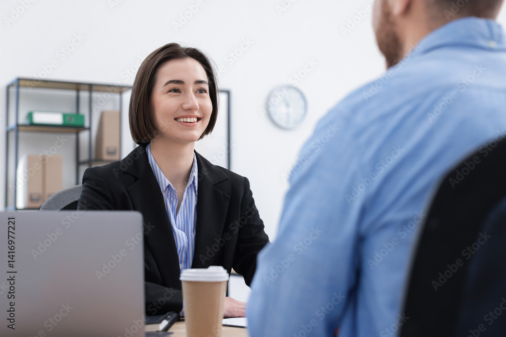 Recruiter and candidate having job interview at desk in office Recruiter and candidate having job interview at desk in office