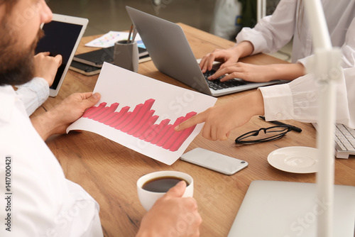 Business team holding cup o...