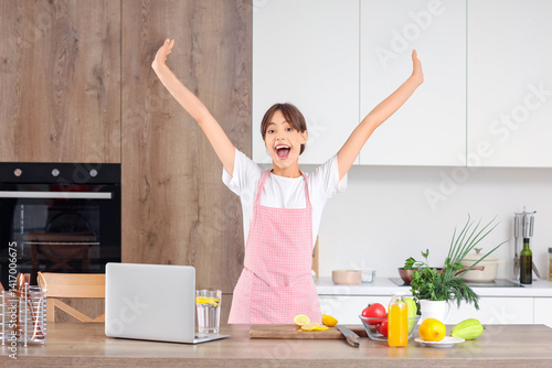 Happy young housewife at ta...