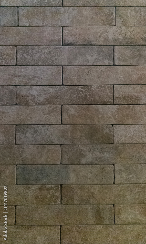 Fototapeta premium The brick wall is grey. Brick grey background. The texture of a gray brick. Vertical image.