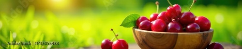 Obraz na płótnie Sun-drenched cherries overflowing a wooden bowl, idyllic grassy setting, bright, summer w salonie